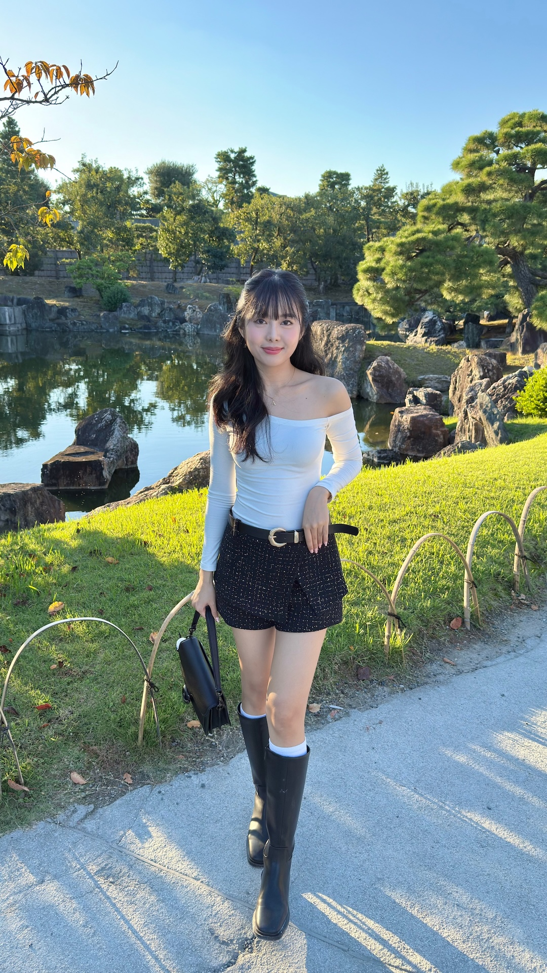 Aiko Mizukami smiling in a red plaid shirt and tortoise shell glasses